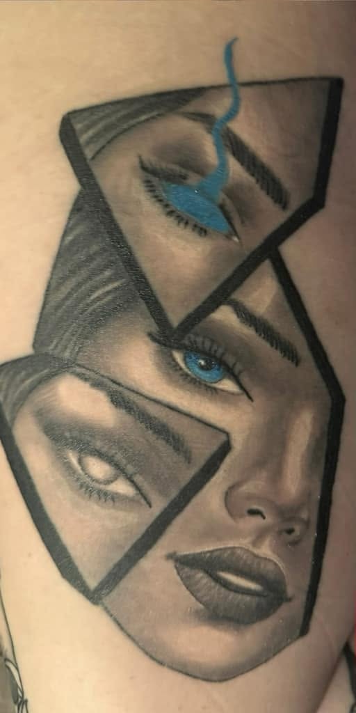 Black and gray portrait broken into shifted fragments, with one blue eye