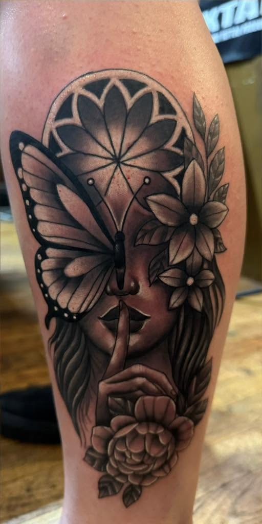 Black and gray portrait with a moth and flowers and a finger raised to the lips